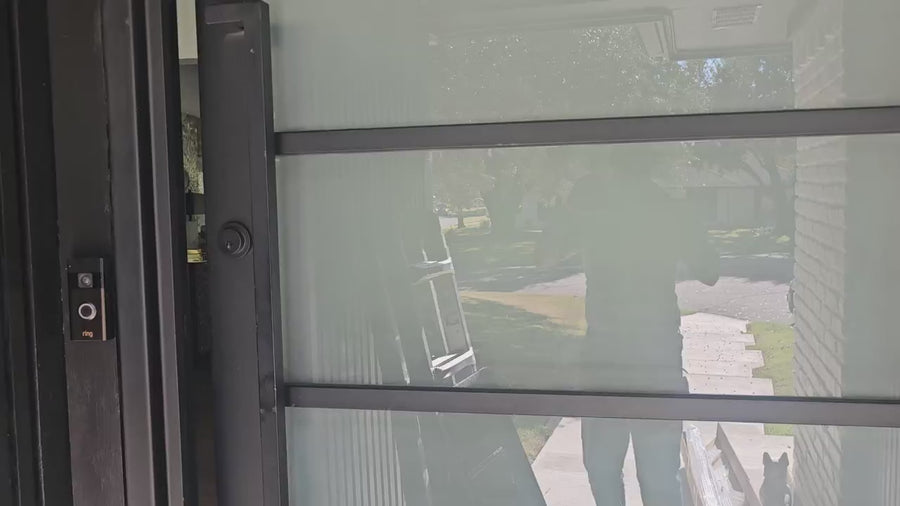 Returning customer’s large-window installation with black cassette and black solar shades complementing contemporary decor.